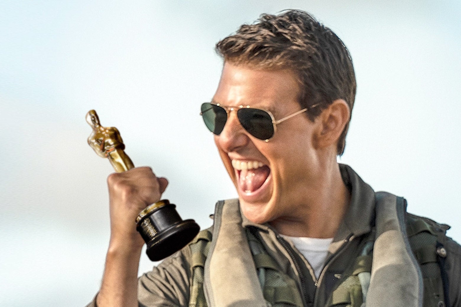 A still from Top Gun: Maverick shows Tom Cruise in aviators and a flight jacket, pumping his right fist. In that fist is photoshopped an Oscar.
