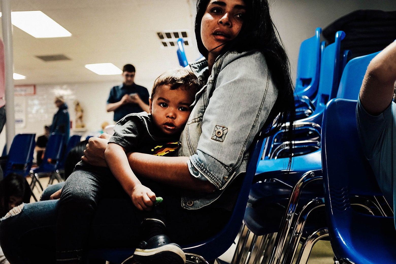 A woman who identified herself as Jennifer sits with her son Jaydan at the Catholic Charities Humanitarian Respite Center.
