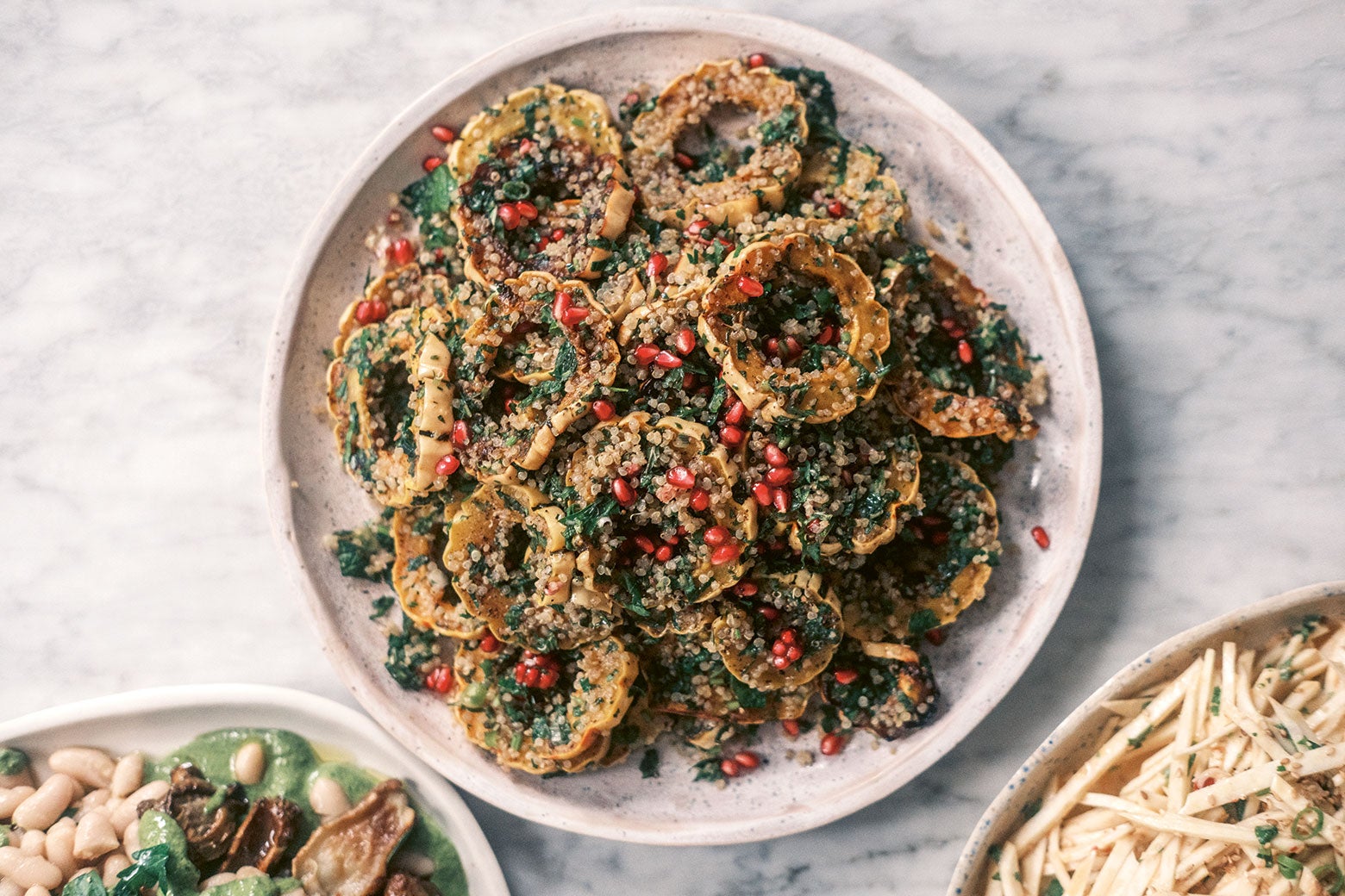 recipes Squash and quinoa piled on a plate with fresh herbs.