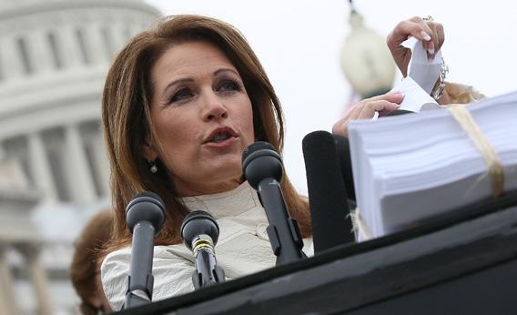 U.S. Rep. Michele Bachmann tears a page from the national health care bill during a press conference at the U.S. Capitol March 21, 2012 in Washington, DC. 