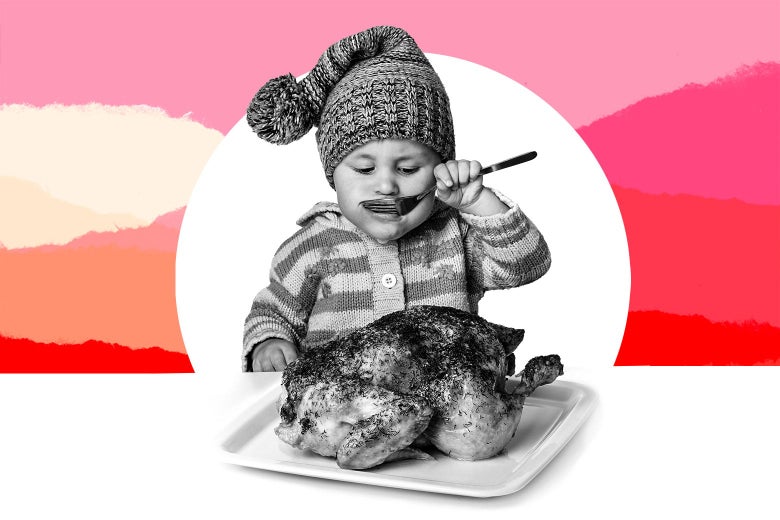 A baby sits with a fork and a whole roast chicken.