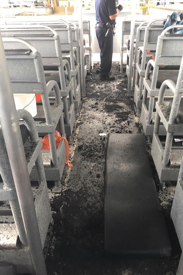 The seats and floor of the boat, with layers of ash and debris
