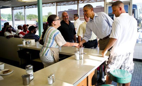 US President Barack Obama shakes hands with waitress Toni as he arrives at Ann's Place in Akron, Ohio, July 6, 2012.