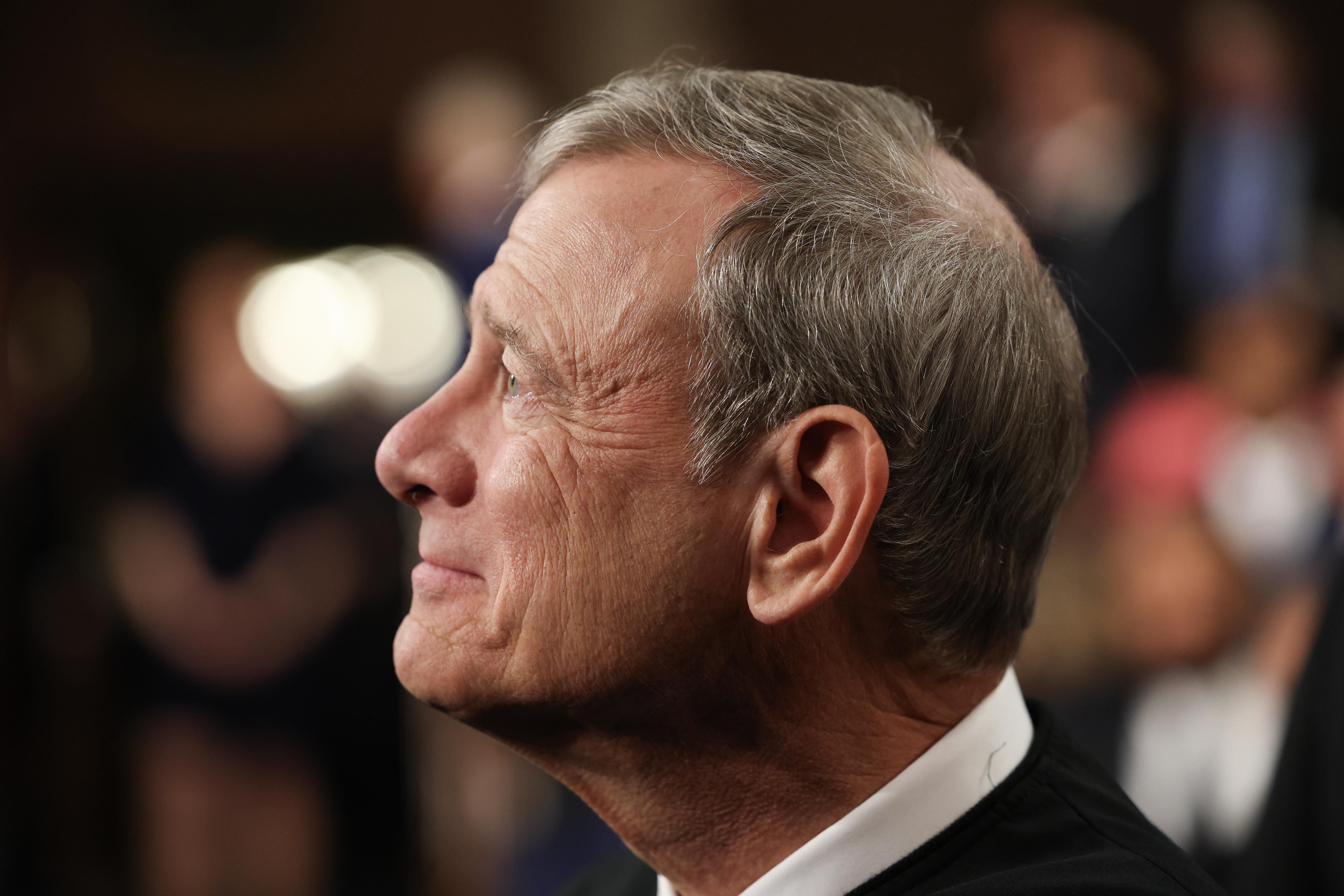John Roberts looks up, seen in profile.