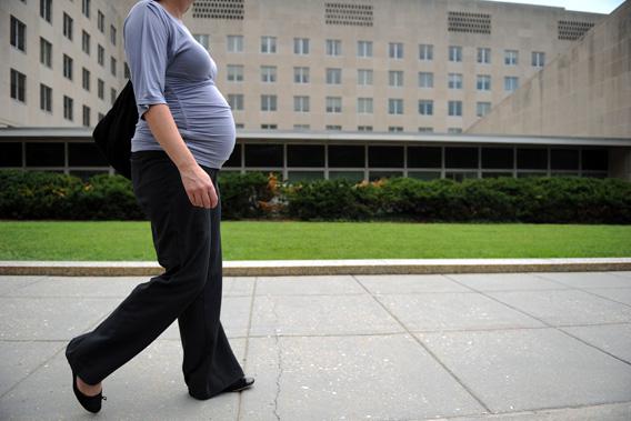 A pregnant woman due in six weeks walks outside the State Department on August 5, 2010 in Washington, DC.