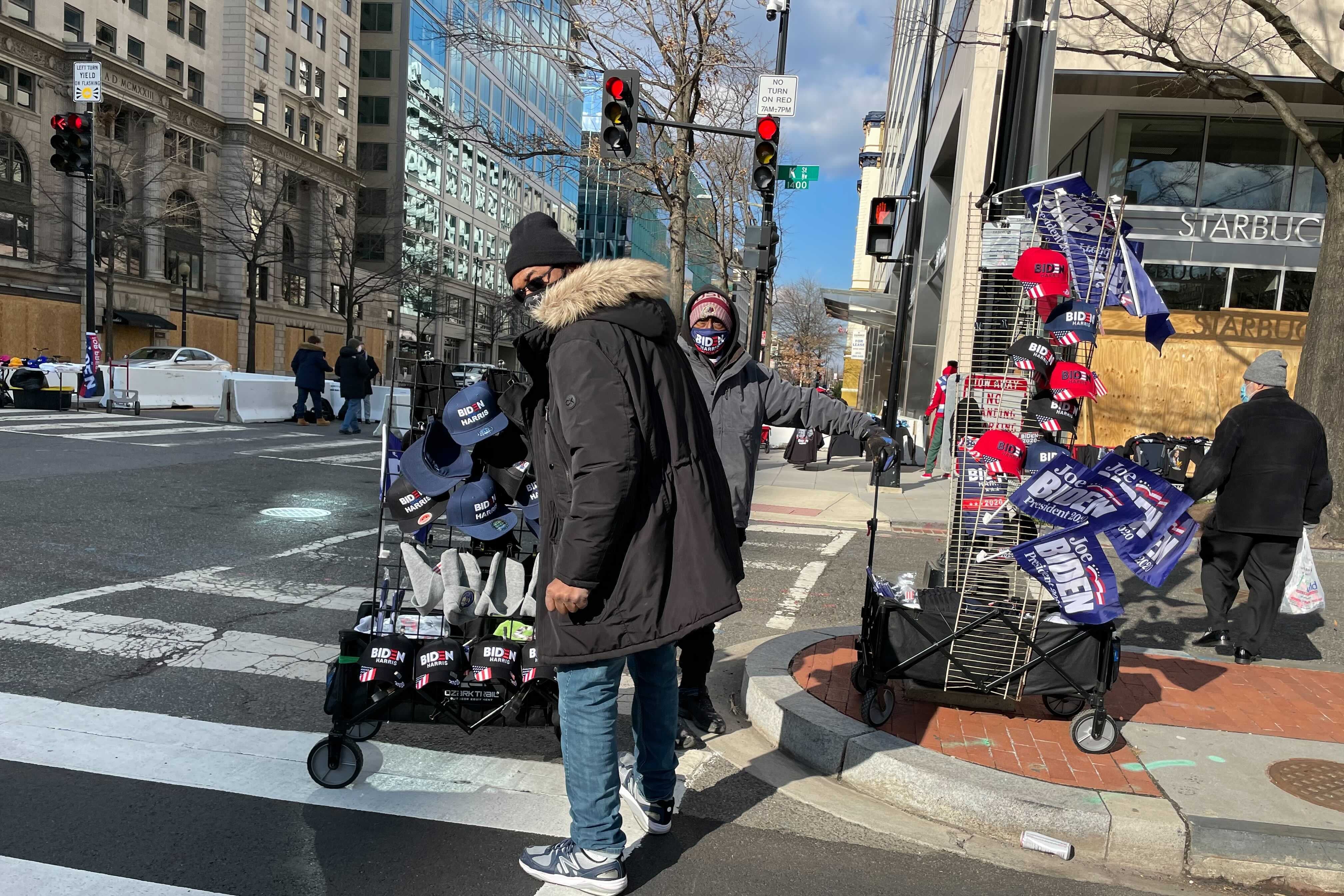 A street vendor in D.C. with carts full of Biden-Harris flags, hats, and other memorabilia