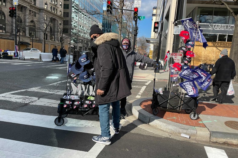 A street vendor in D.C. with carts full of Biden-Harris flags, hats, and other memorabilia