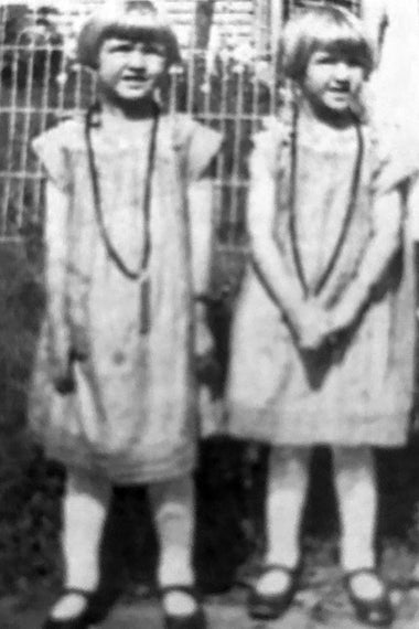 Two girls, Irene and Arlene, in matching dresses.