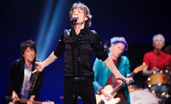 Mick Jagger (front) performs with Ronnie Wood (rear left), Keith Richards (rear center), and Charlie Watts of the Rolling Stones at a concert during the band's "50 and Counting" tour in Chicago, May 28, 2013.