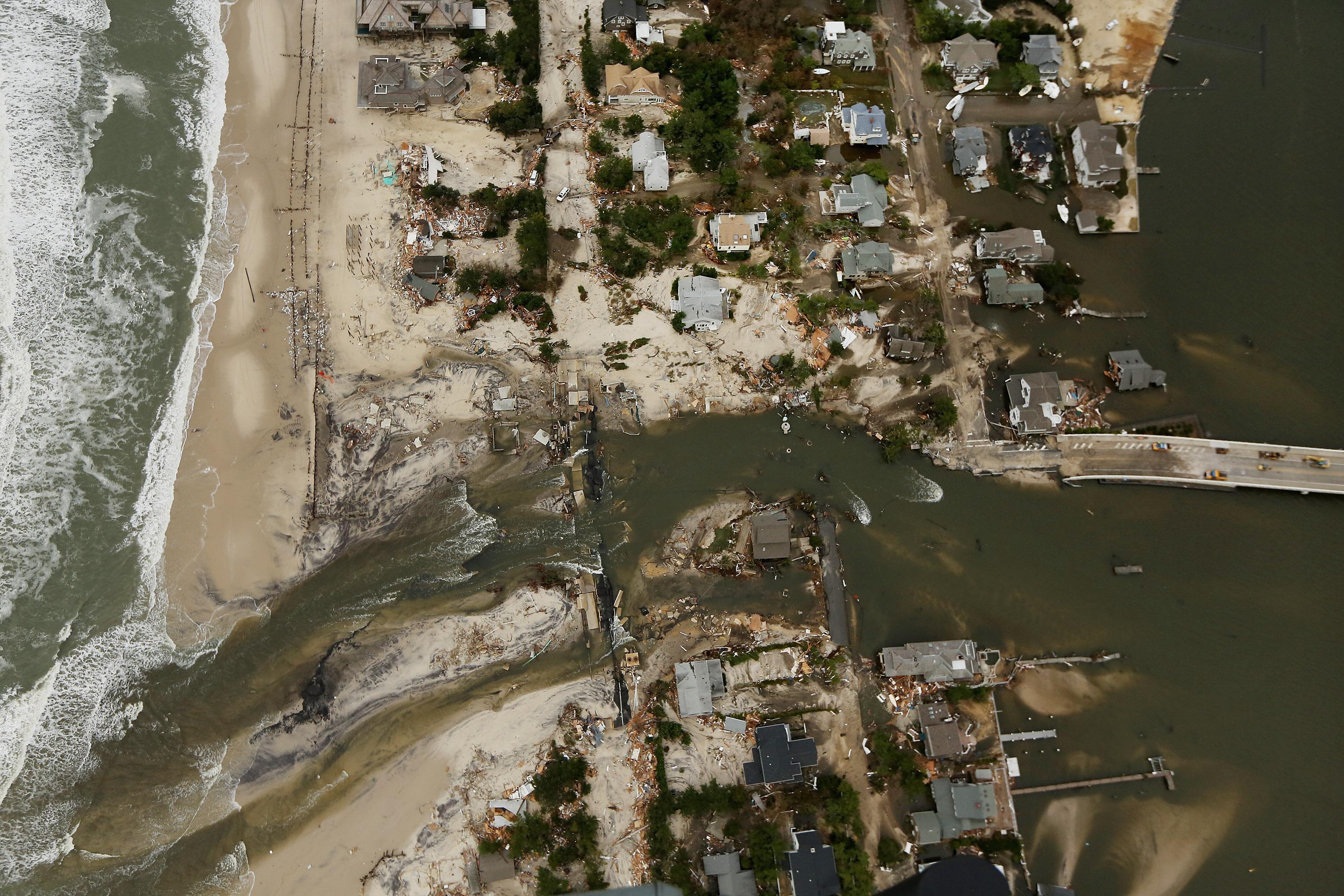 Homes sit in ruin at the end of a bridge wrecked by flooding from Superstorm Sandy on October 31, 2012 in Mantoloking, New Jersey.