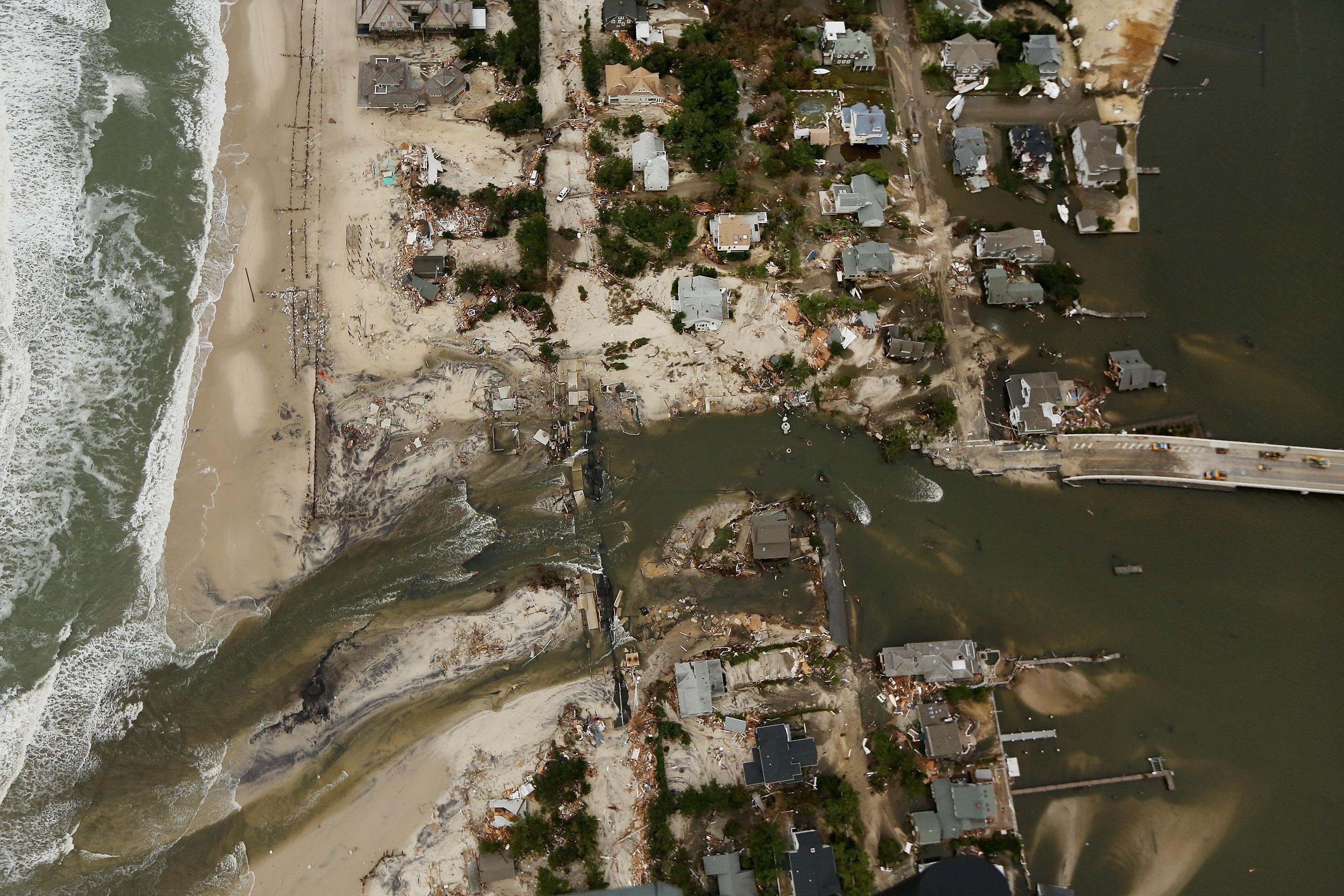 Homes sit in ruin at the end of a bridge wrecked by flooding from Superstorm Sandy on October 31, 2012 in Mantoloking, New Jersey. 