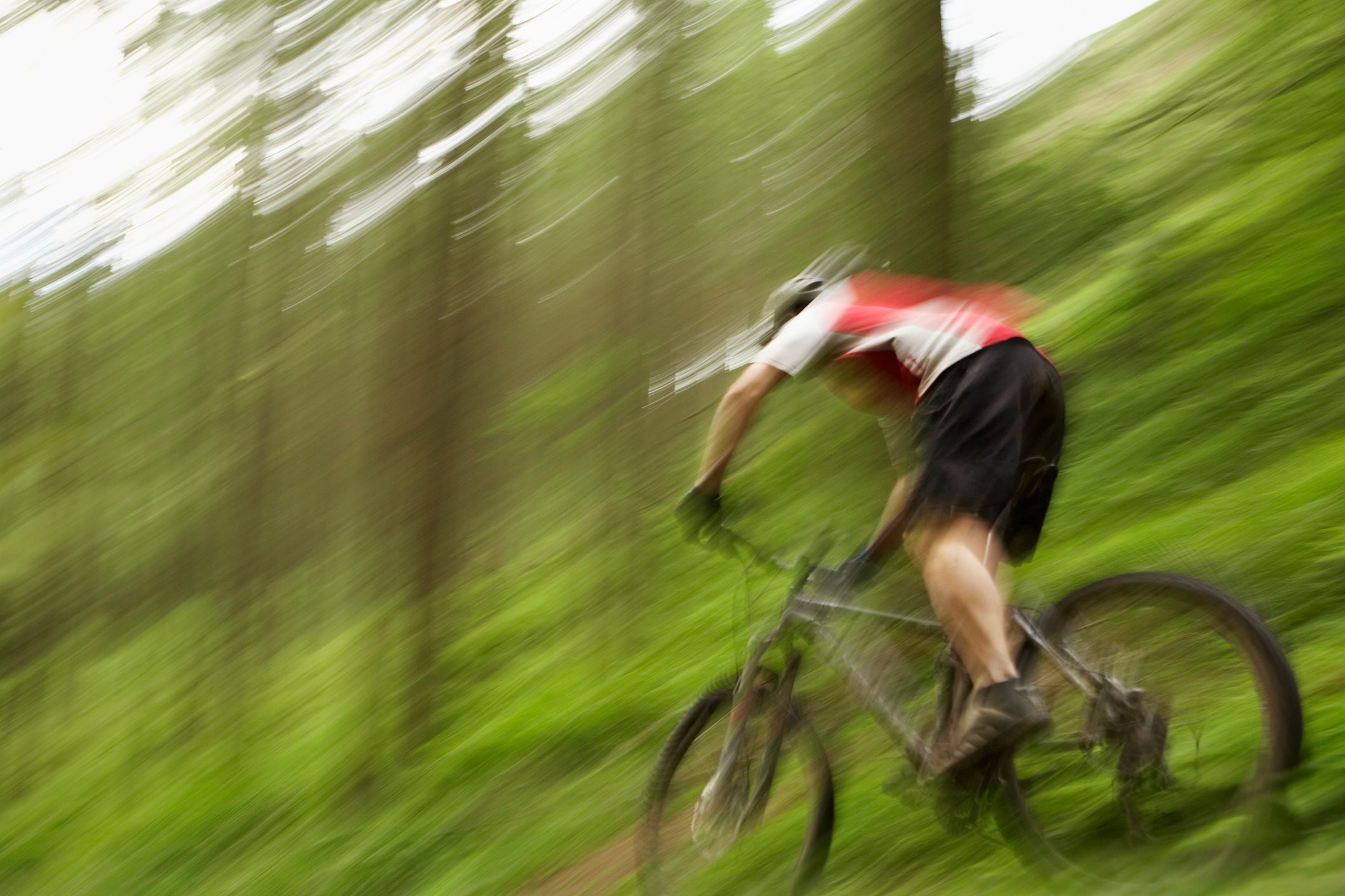 A cyclist speeds along a trail.