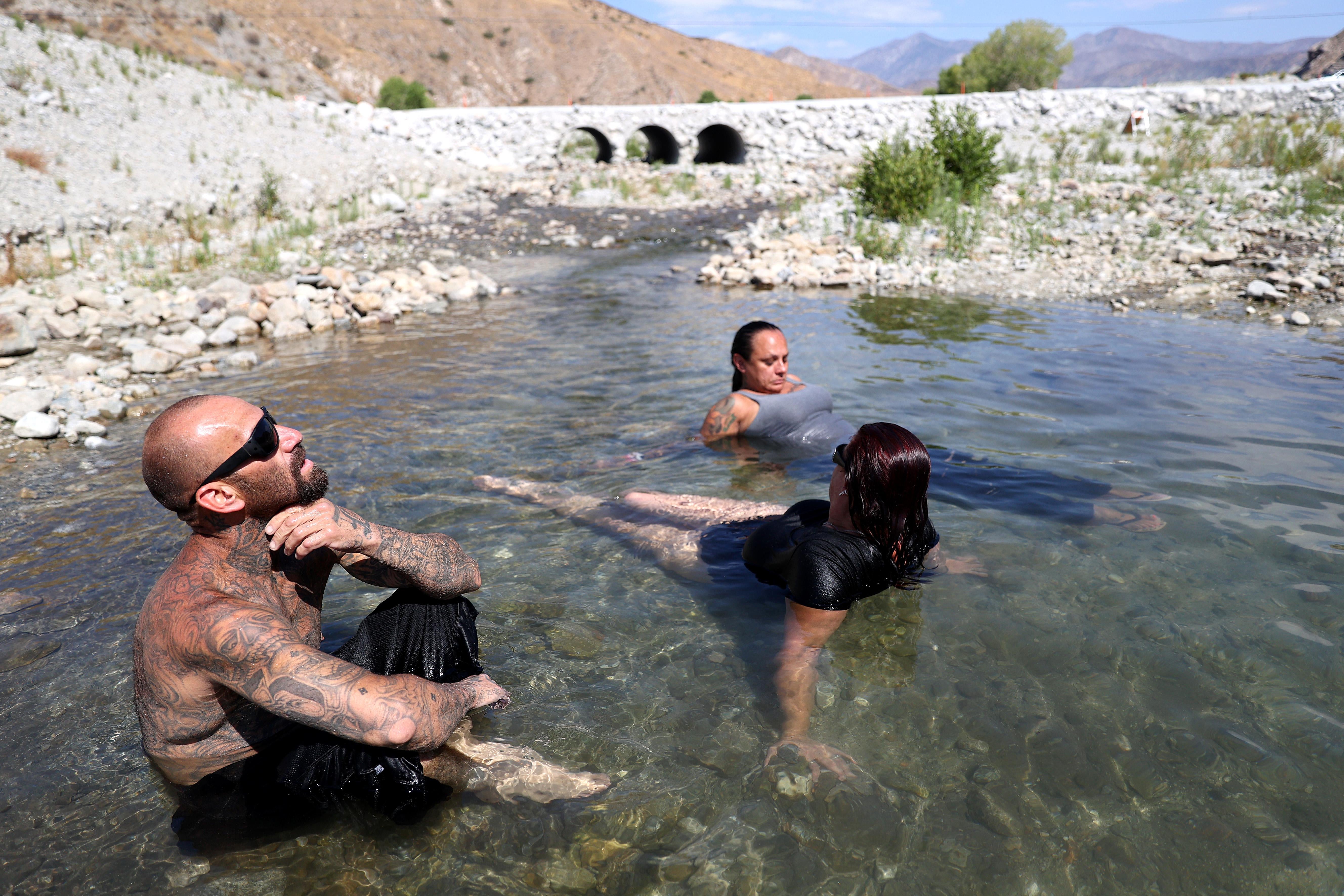 Southern California residents cool off in the Whitewater River on July 10, 2021 in Whitewater, California. 