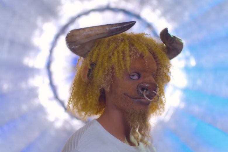 Man with yellow curly hair and a bull mask.
