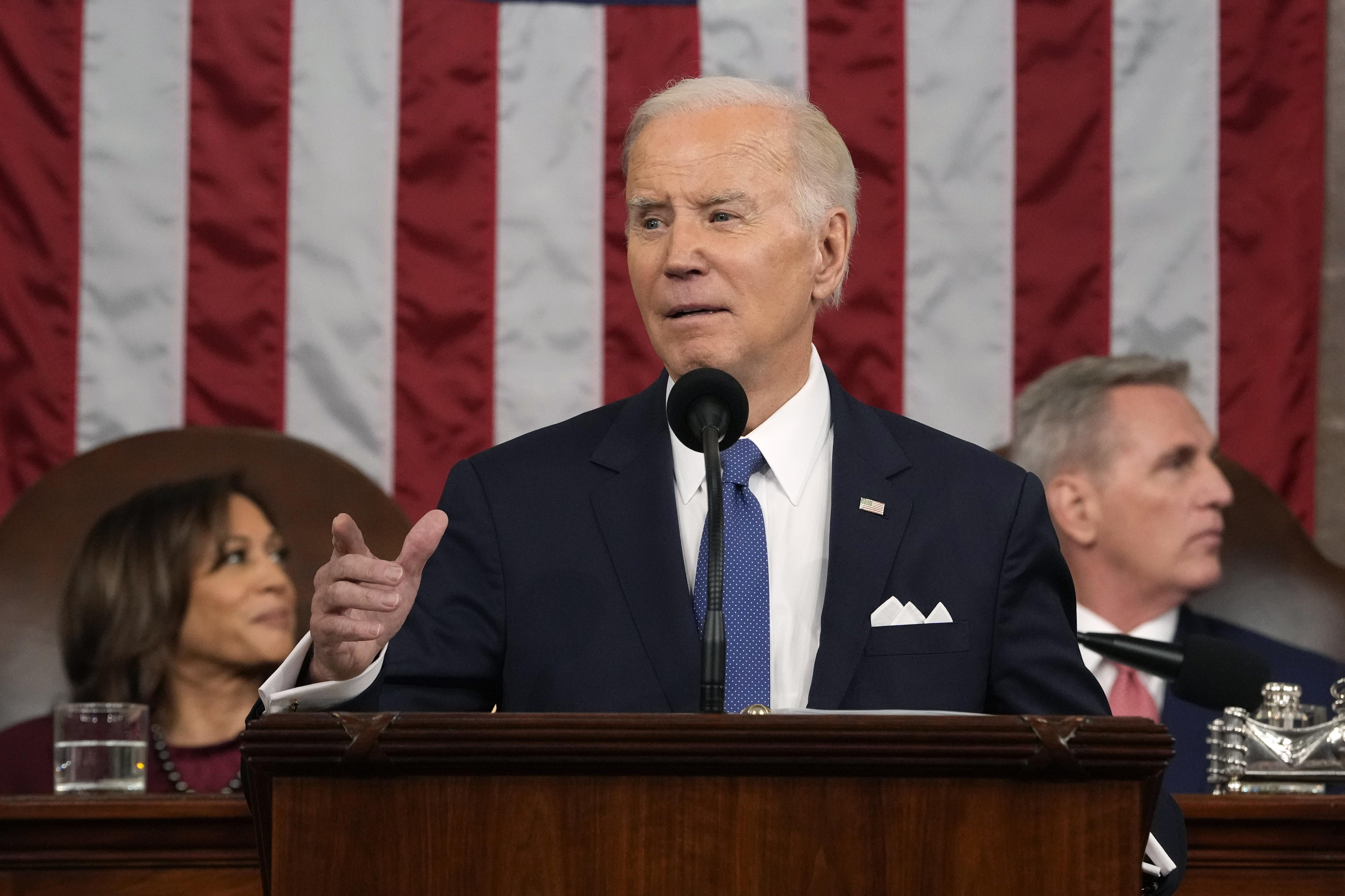 Joe Biden delivering the State of the Union, pointing at the crowd.