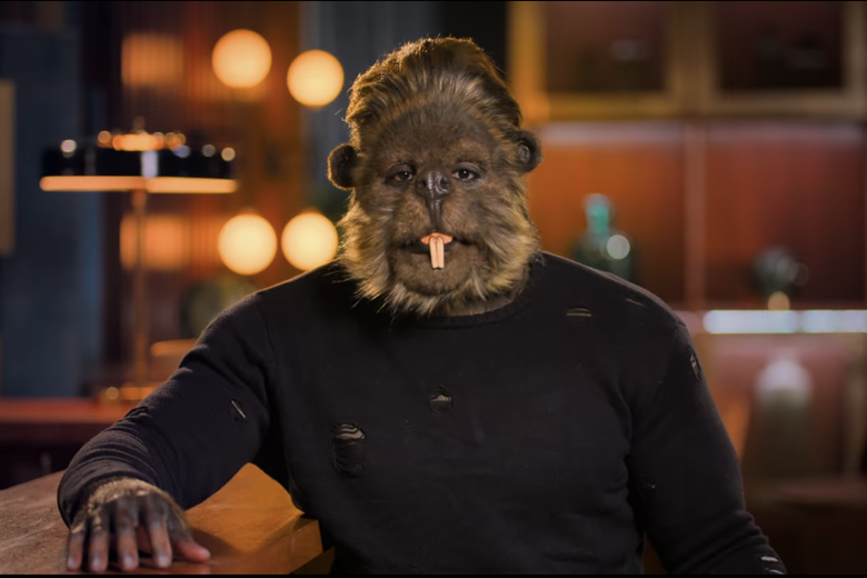 Man in black shirt wearing a beaver head with buck teeth.