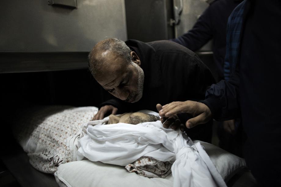 A relative mourns over the body of Maisara Abu Hamdiyeh, a Palestinian prisoner who died of cancer while in Israeli detention, at Al-Ahli hospital in the West Bank city of Hebron ahead of his funeral on April 4, 2013.