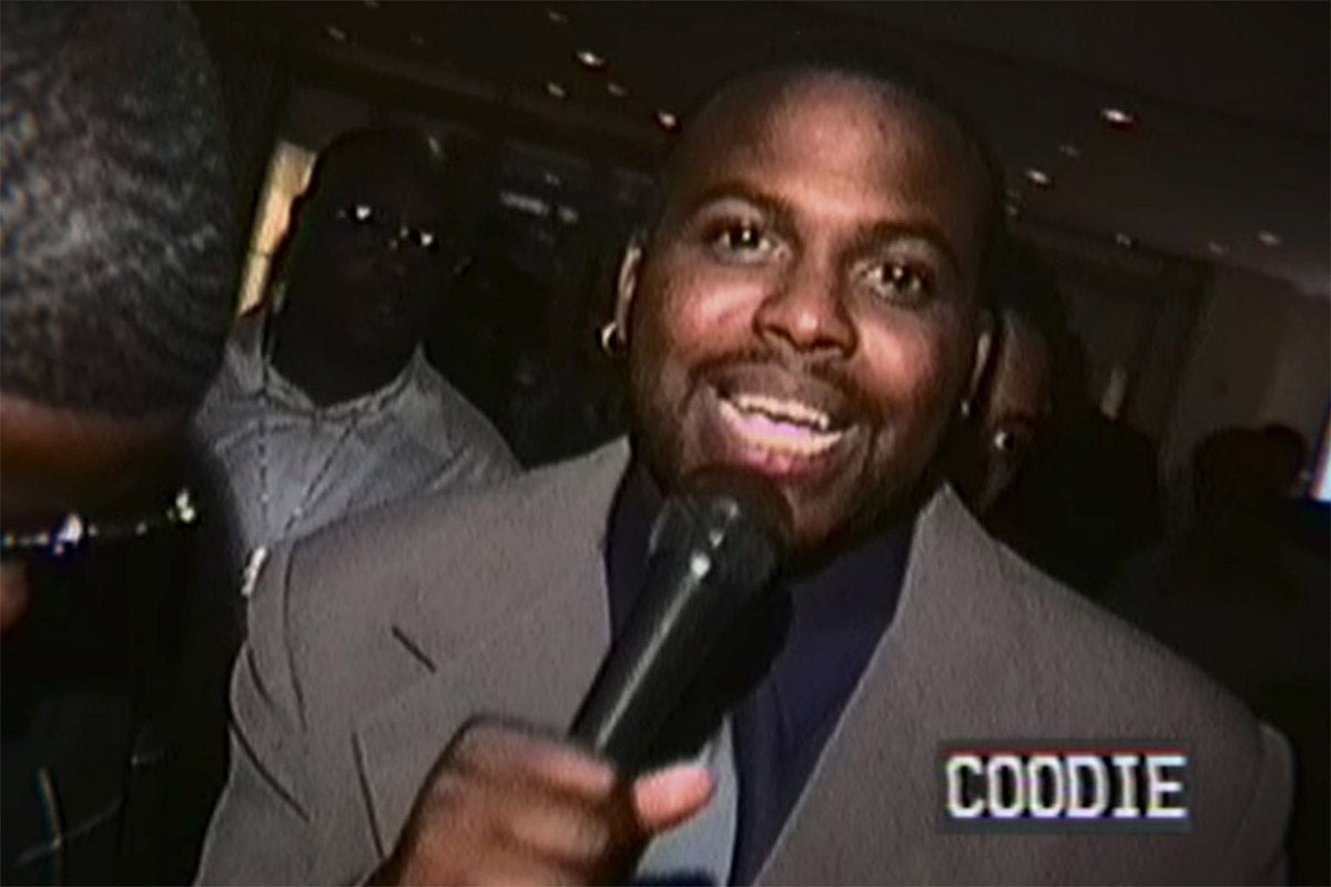 Clarence "Coodie" Simmons holding a microphone and facing the camera