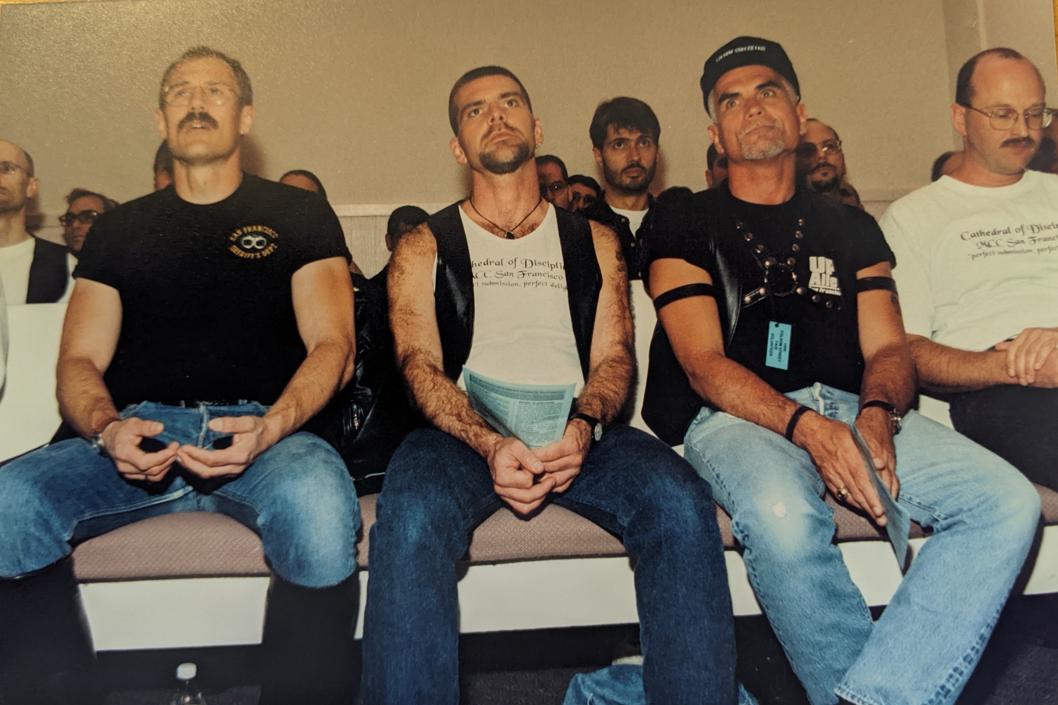 Four men on the pews at church in leather.