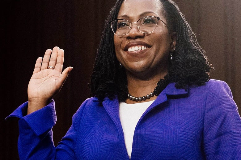 Judge Ketanji Brown Jackson smiles broadly and raises her right hand as she takes the oath.