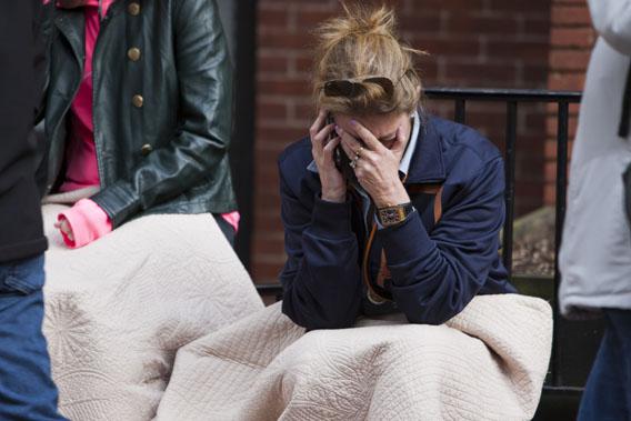A woman talks on the phone after two explosions interrupted the running of the Boston Marathon in Boston, Massachusetts April 15, 2013.