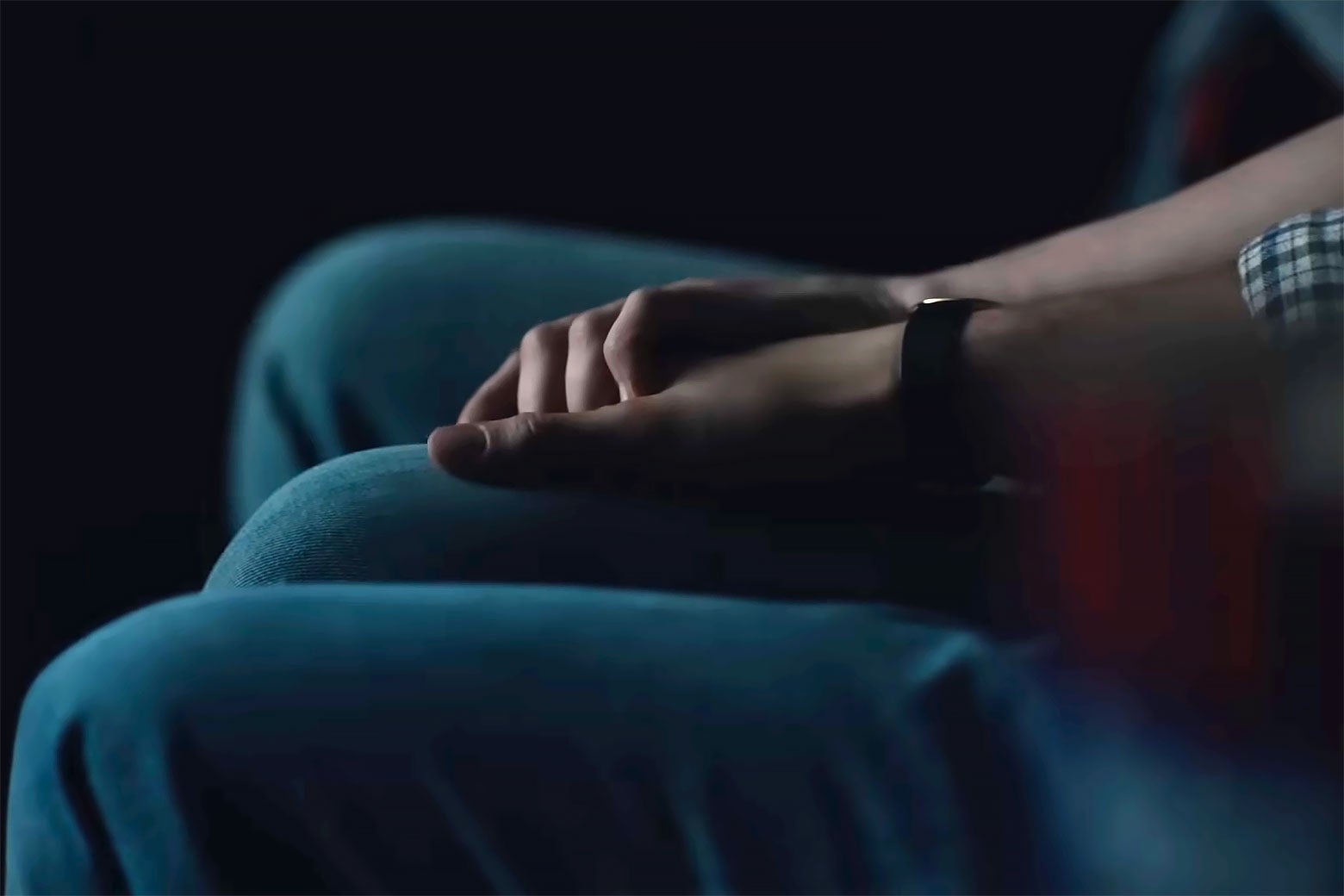 A close-up of two men holding hands.