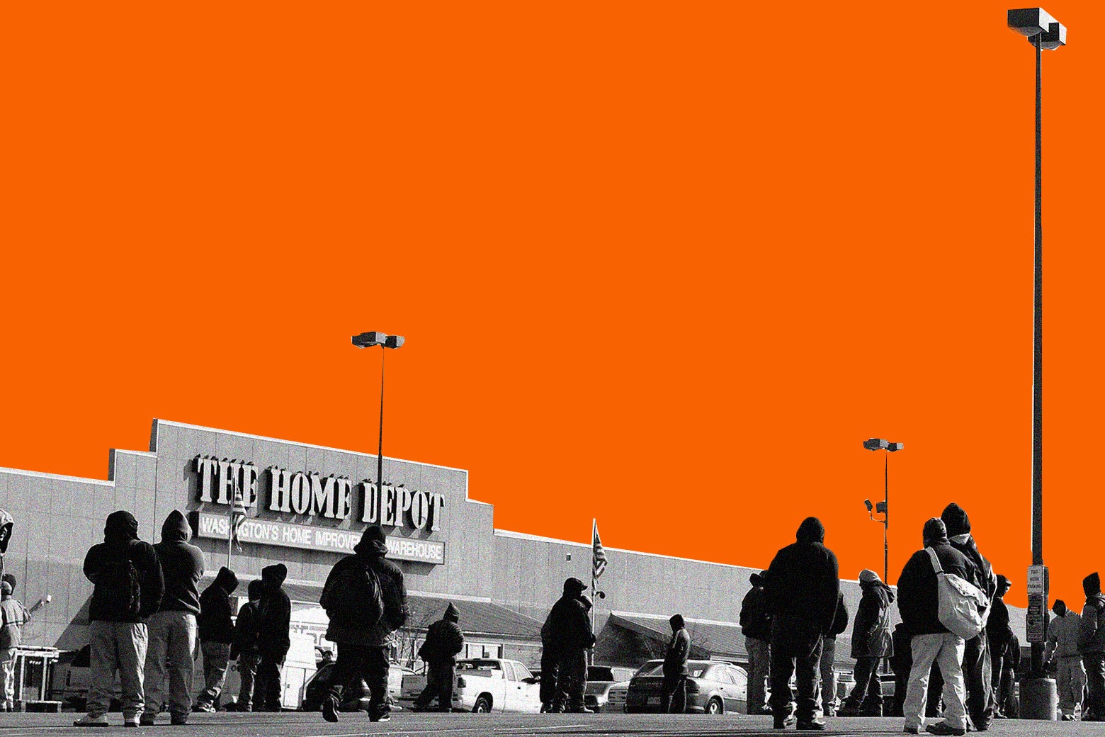 Men are standing facing the same direction in a Home Depot parking lot. 