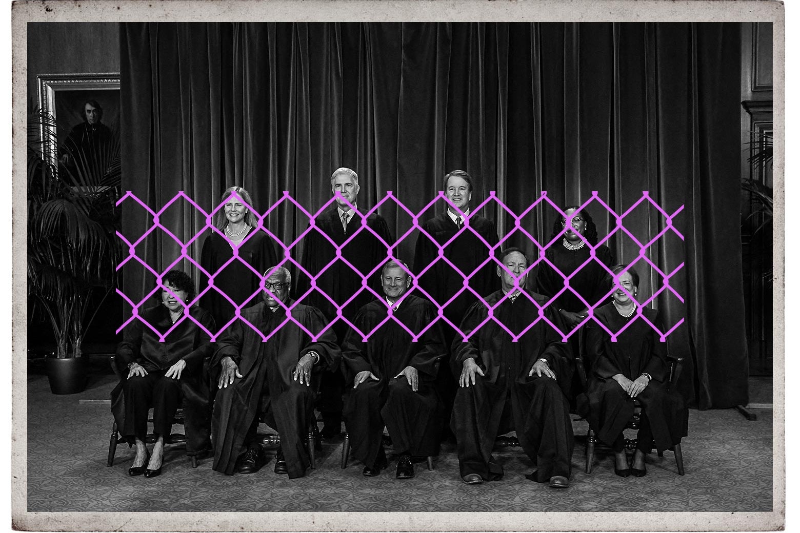 A framed black-and-white image of the Supreme Court justices with a purple fence in front of them.