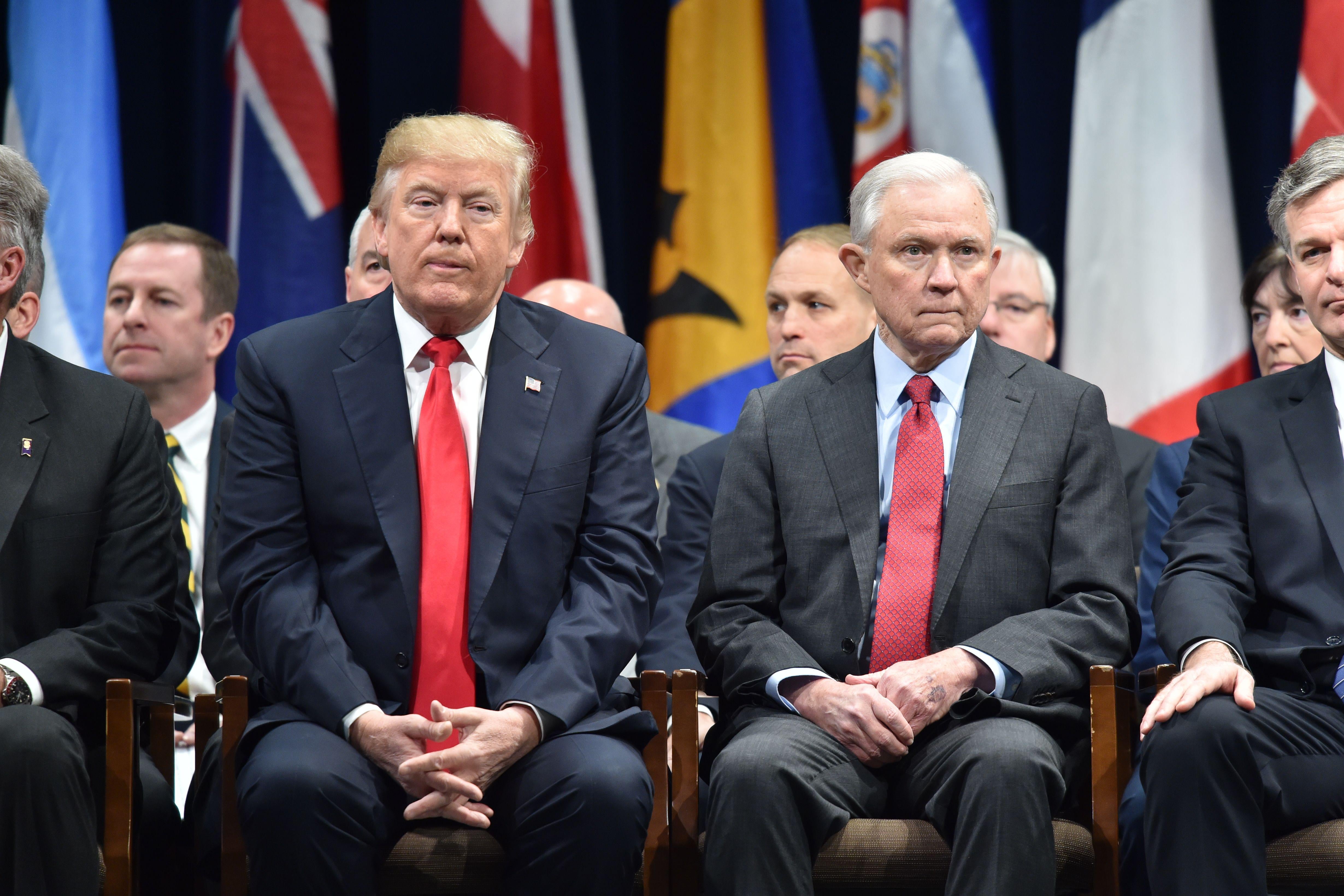 President Donald Trump sits with Attorney General Jeff Sessions on December 15, 2017 in Quantico, Virginia, before participating in the FBI National Academy graduation ceremony. 
