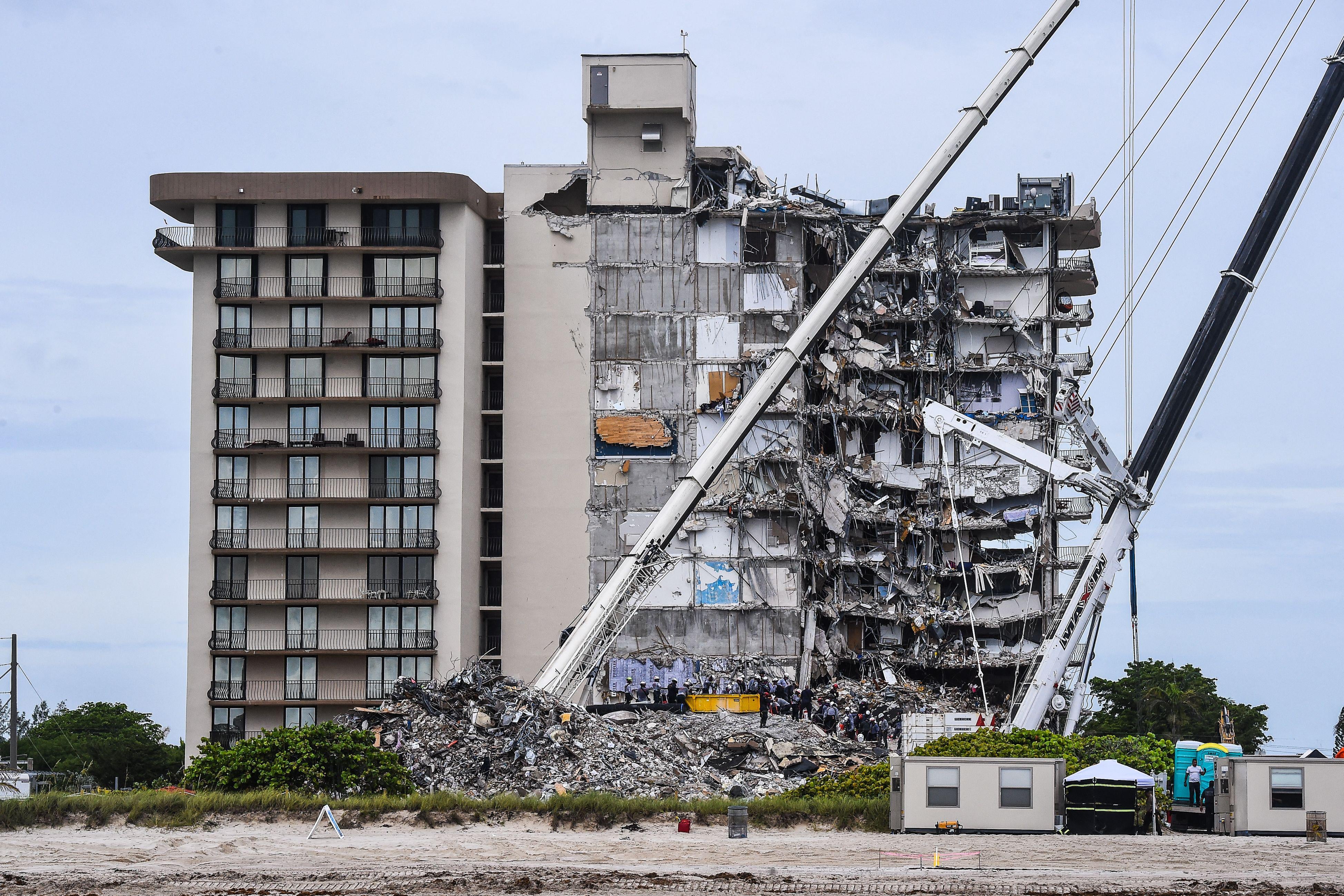 A partially collapsed building on a beach.