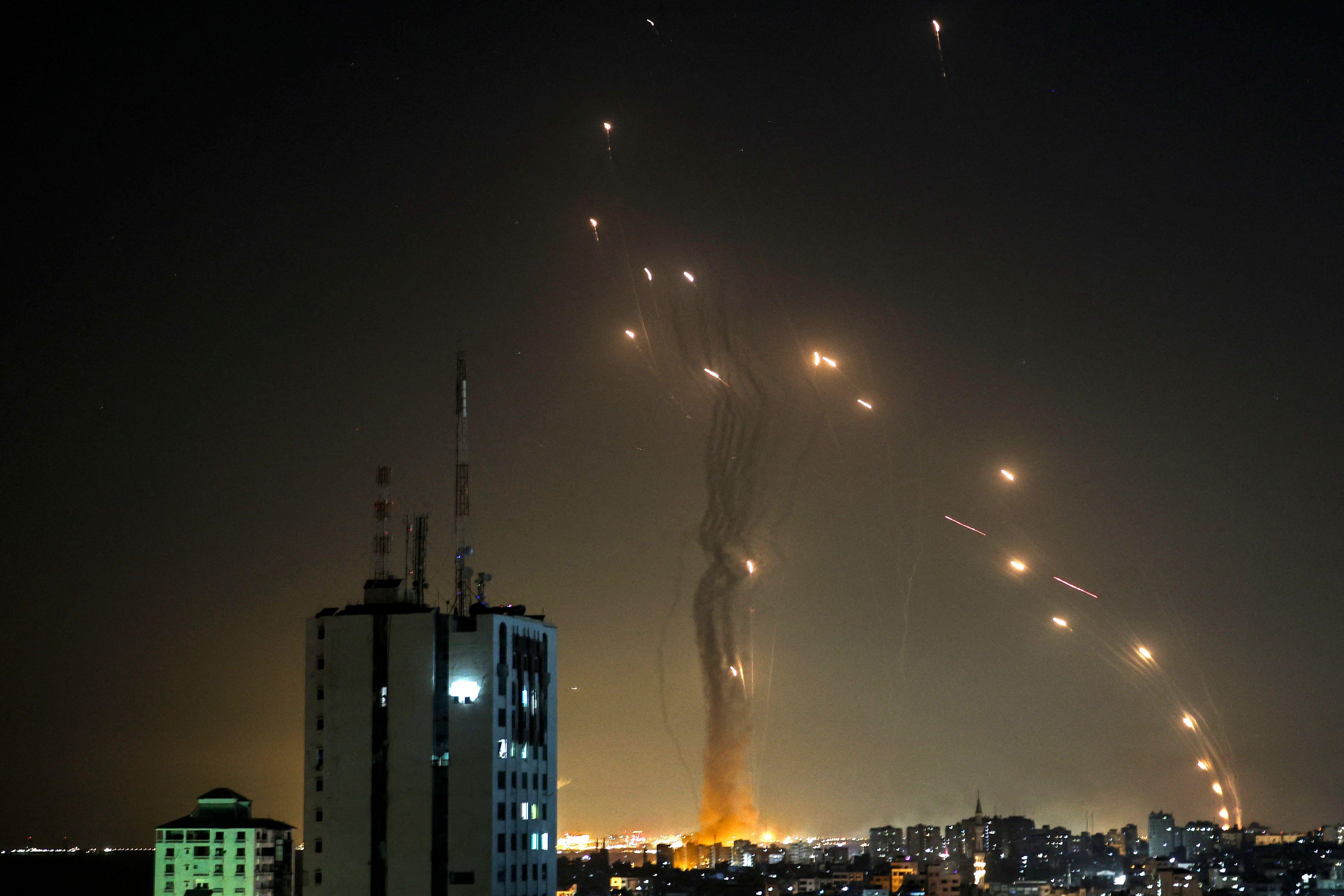 Explosions in an arc across the night sky over Gaza.