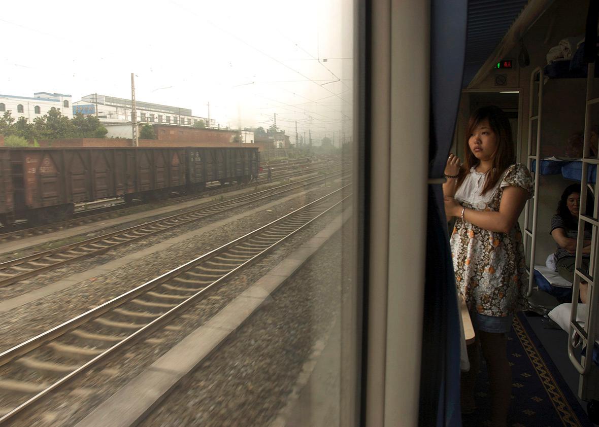 A passenger on a train from Beijing to Chengdu looks out the win