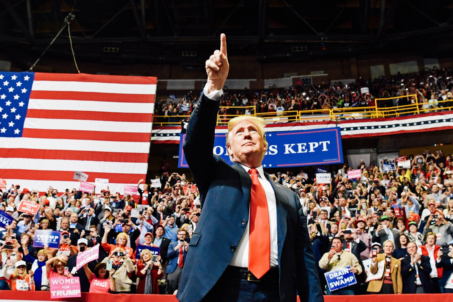 Donald Trump points at the crowd at a rally.