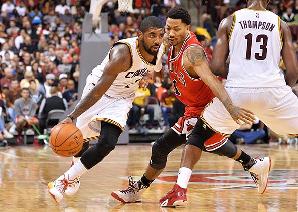 Kyrie Irving #2 of the Cleveland Cavaliers drives around the defense of Derrick Rose #1 of the Chicago Bulls.
