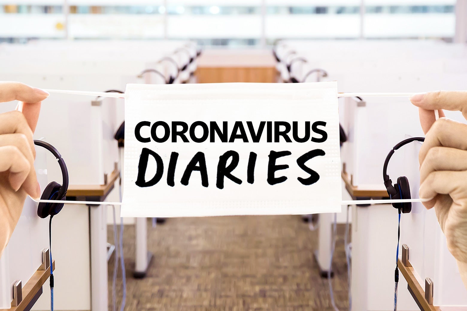 A row of call center cubicles, with a "Coronavirus Diaries" banner stretched over it. 