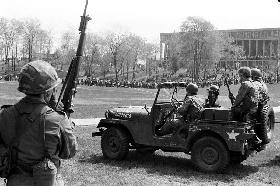 Guardsmen watch from a distance as students gather in the Commons late in the morning of May 4, 1970.