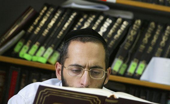 A religious Jewish Kabbalah (Jewish mysticism) scholar reads from the Talmud holy book during his studies at leading Kabbalist Rabbi Yitzhak Kadouri's synagogue August 4, 2004 in Jerusalem, Israel. 