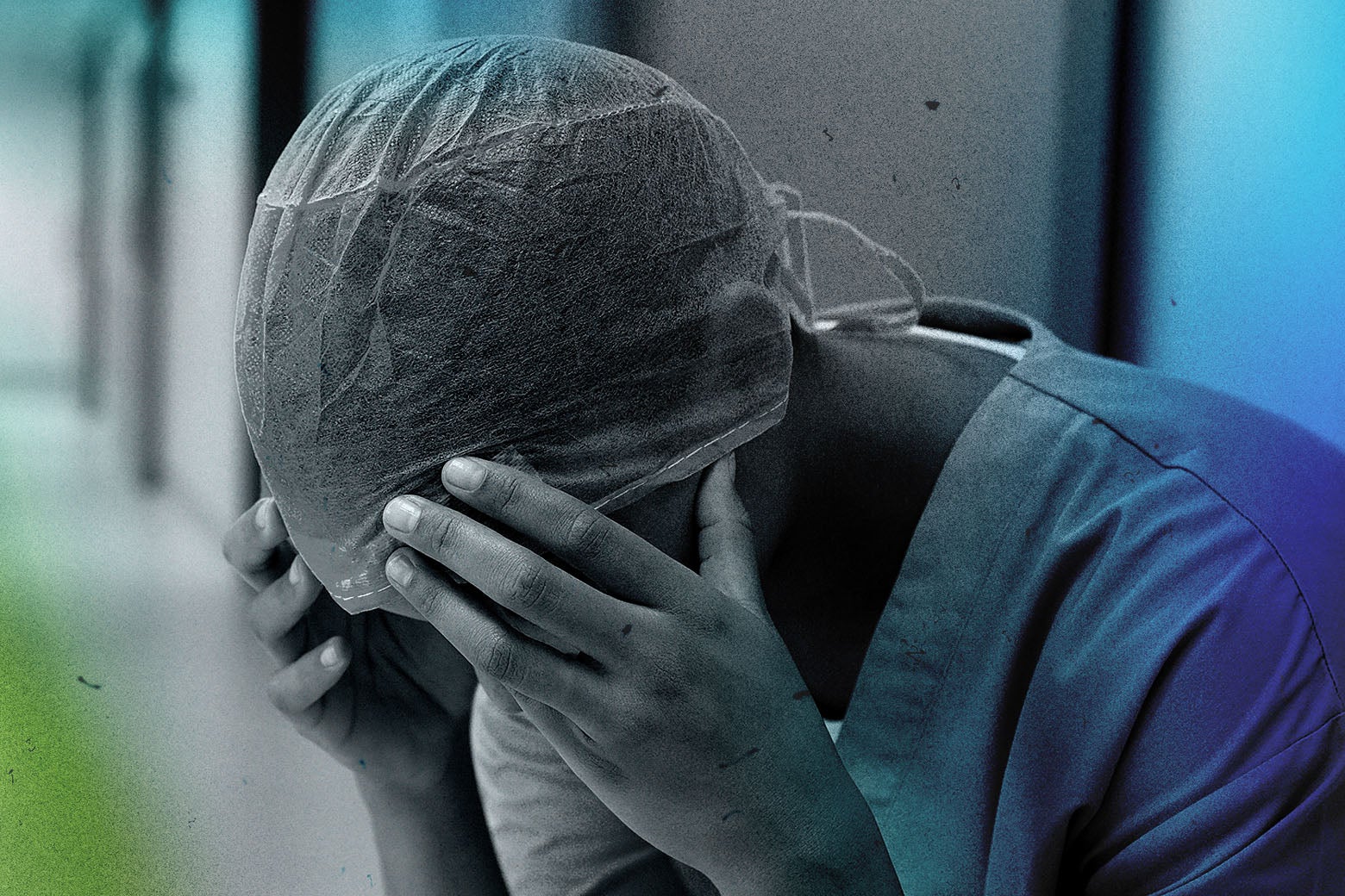 A nurse resting her head in her hands
