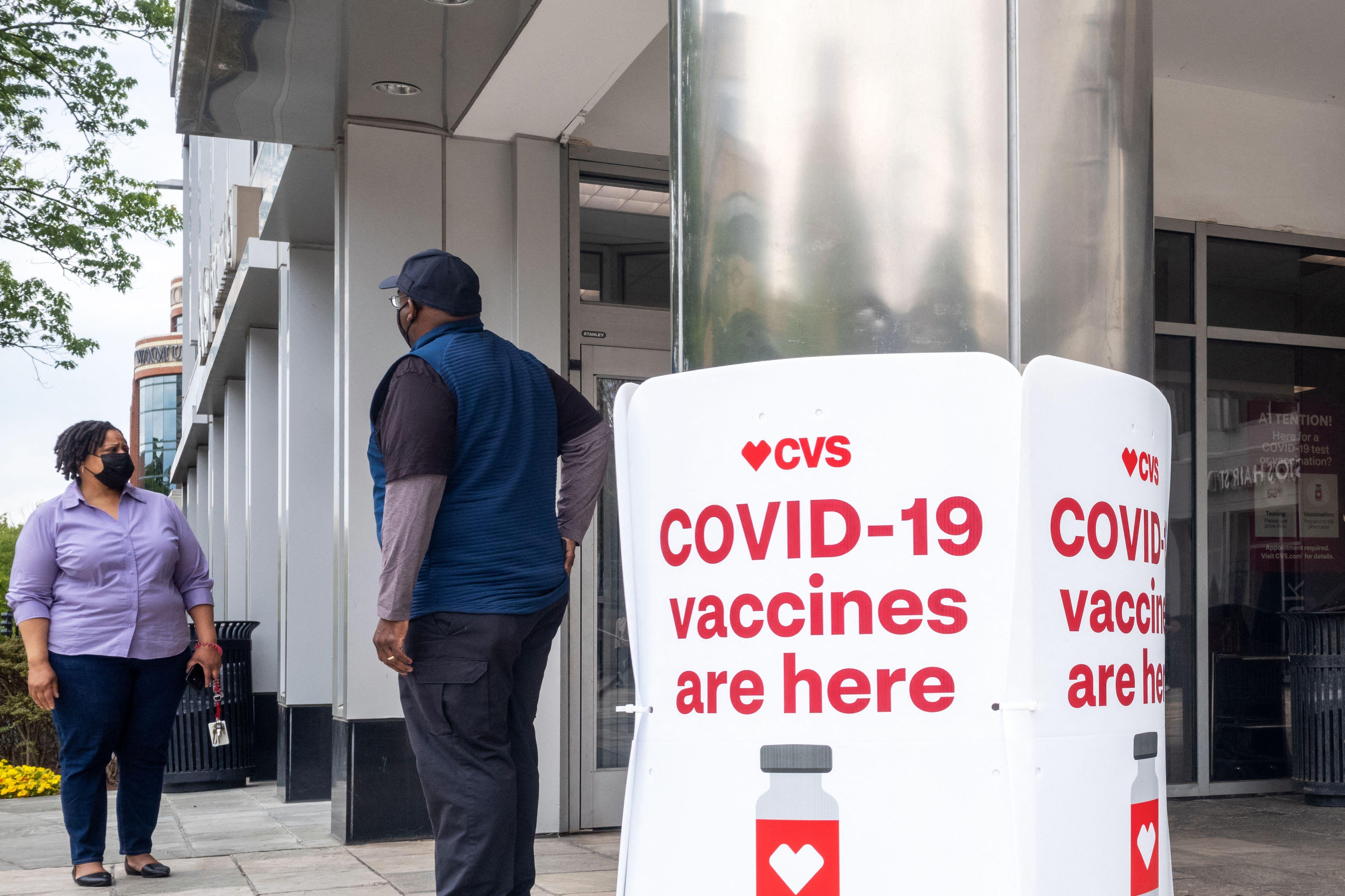 Signs offering COVID-19 vaccinations outside of a CVS pharmacy in Washington, DC.  
