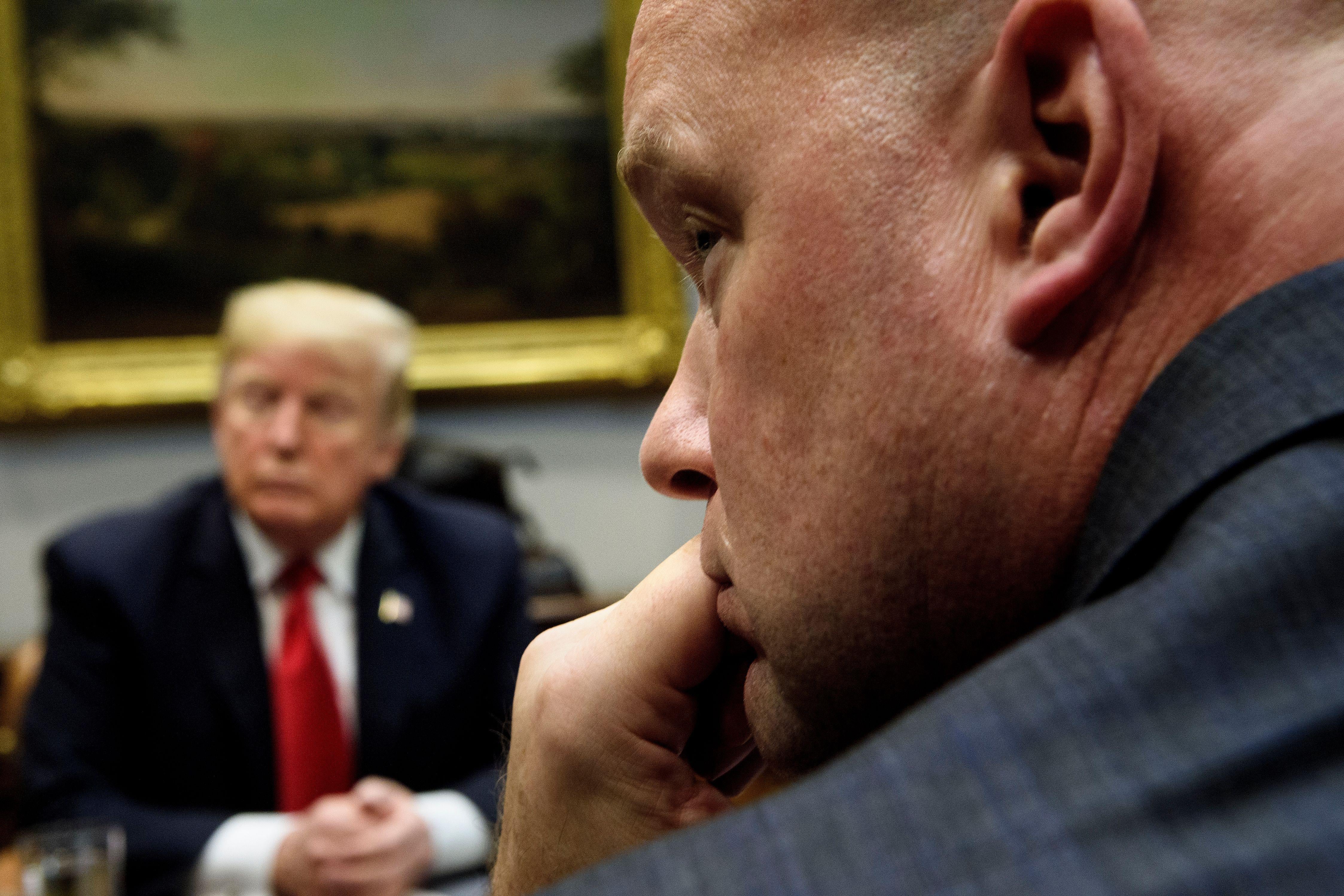 President Donald Trump and acting Attorney General Matthew Whitaker listen during a roundtable discussion about school safety in the Roosevelt Room of the the White House on December 18, 2018.