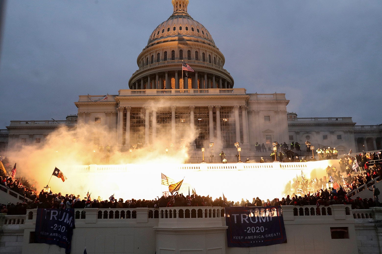 An explosion caused by a police munition is seen while supporters of U.S. President Donald Trump gather in front of the U.S. Capitol building.