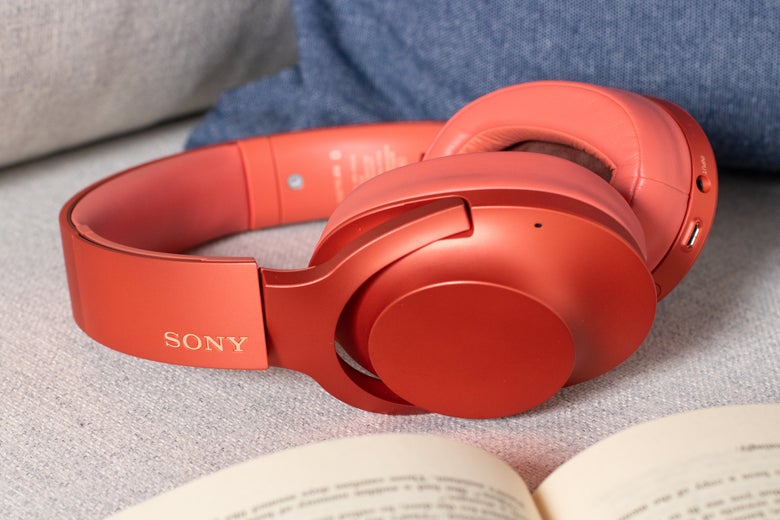 Sony headphones on a cushion near a book