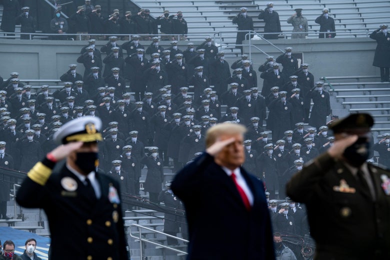 Trump salutes between two servicemen during the 2020 Army-Navy football game.