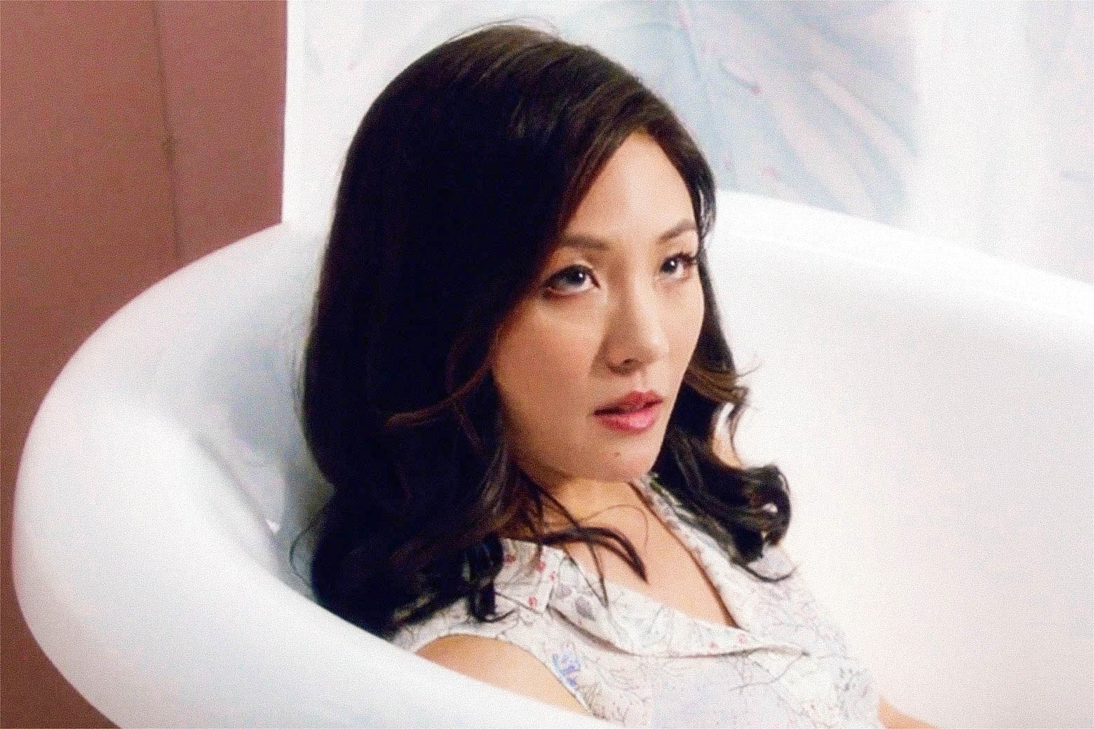 Constance Wu’s character in a bathtub on the show.