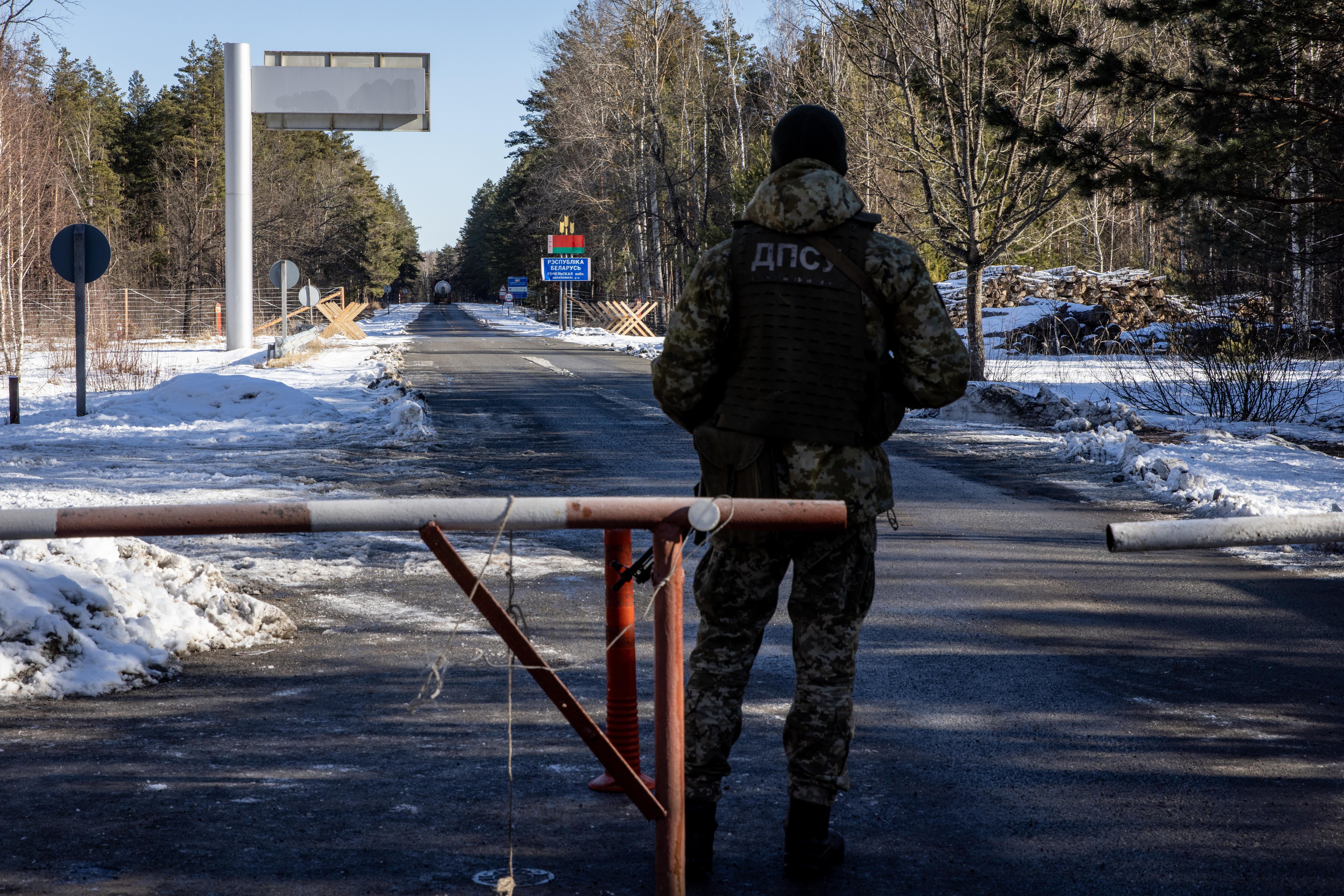 A member of the Ukrainian State Border Guard stands watch at the border crossing between Ukraine and Belarus on February 13, 2022 in Vilcha, Ukraine.