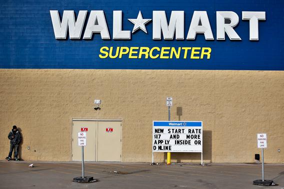 A man stands on a skateboard outside a Wal-Mart store in Williston, N.D., March 13, 2013.