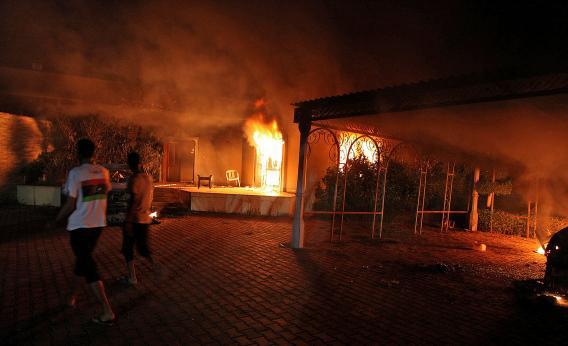 A vehicle and the surround buildings burn after they were set on fire inside the US consulate compound in Benghazi.
