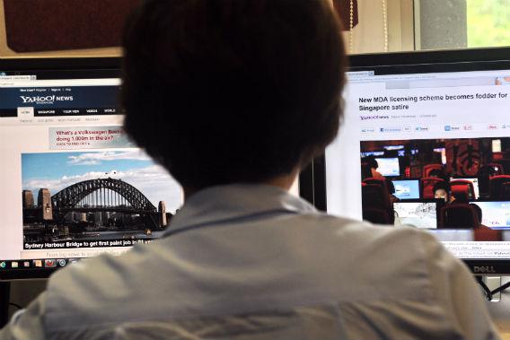 A person browses through media websites on a computer on May 30, 2013. 