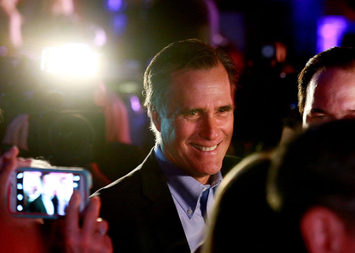 Mitt Romney is greeted by fellow Republicans.