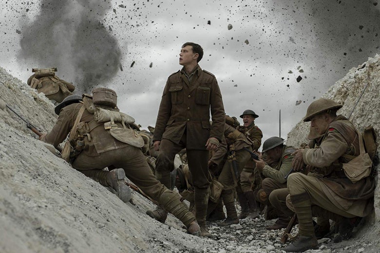 A British messenger stands amid an embattled trench in this still from 1917.